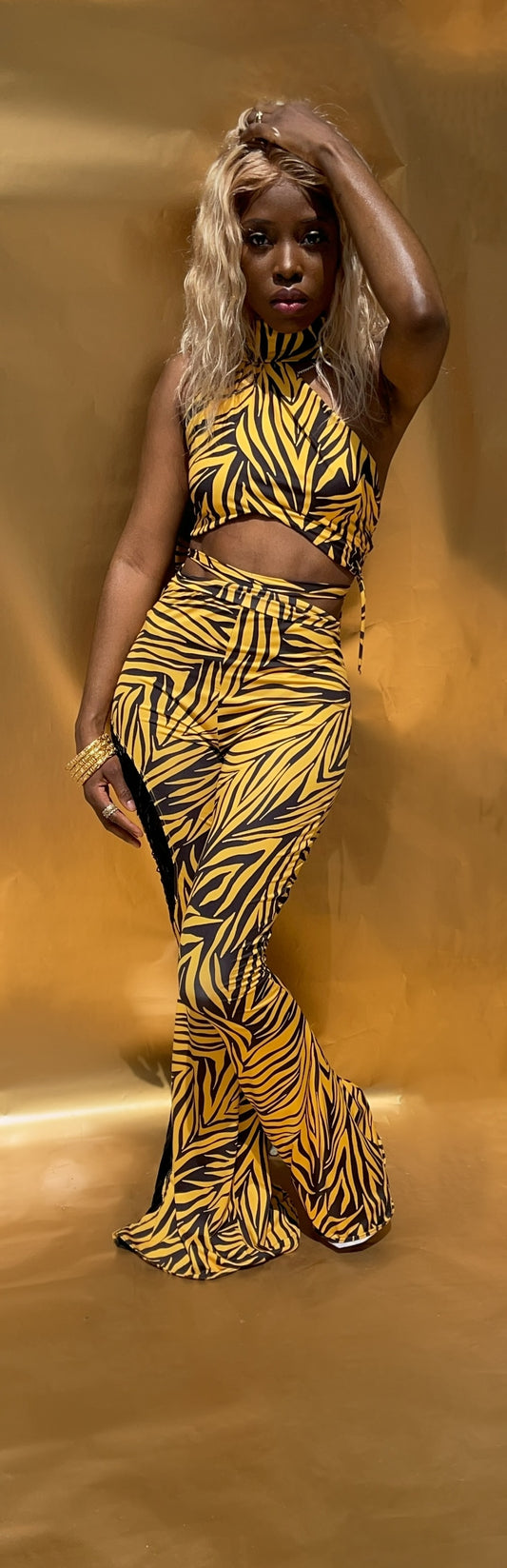 Front view of this yellow and black stripe halter style crop top. Top features a wrap around built in scarf to wear as desired. Top features loop ties on one side, and is fully lined. 