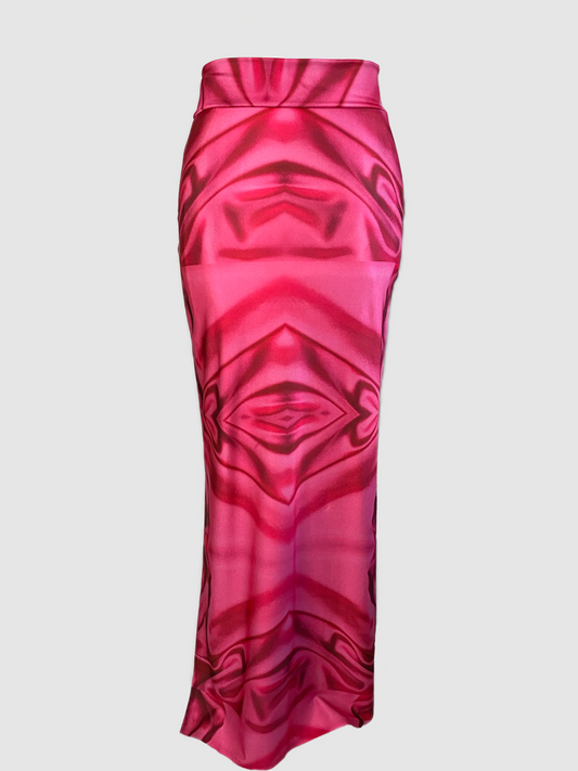 This floor length maxi is made in a soft sheen Lycra. The skirt has stretch and is made to fit slightly contour to the body from waist to hip. The skirt loosen up from hip to floor length. The skirt features a wide waist band, and the print shows images of hearts and geometric shapes. The color of the print comes in hues of light pinks to fuchsia. There is a slit on one side of the skirt. The slit can be worn open or closed with use of the side slit zipper.