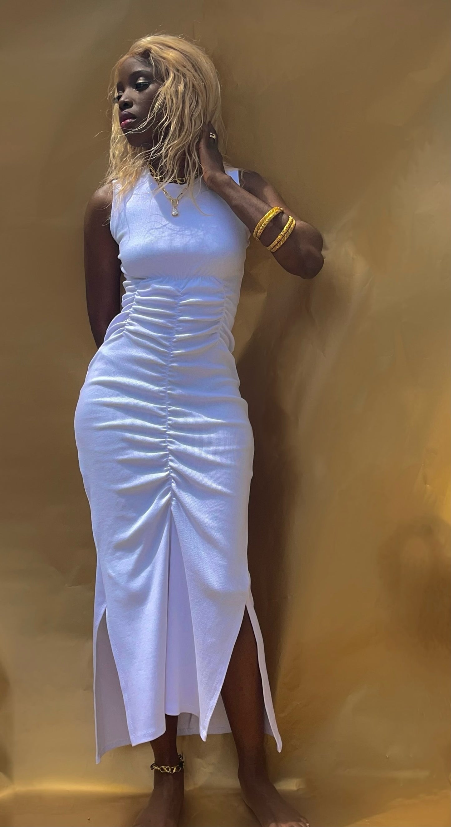 Front view of this bodycon style rib tank dress. Dress showcase gathers that run vertically from the underbust to above the knee in length.