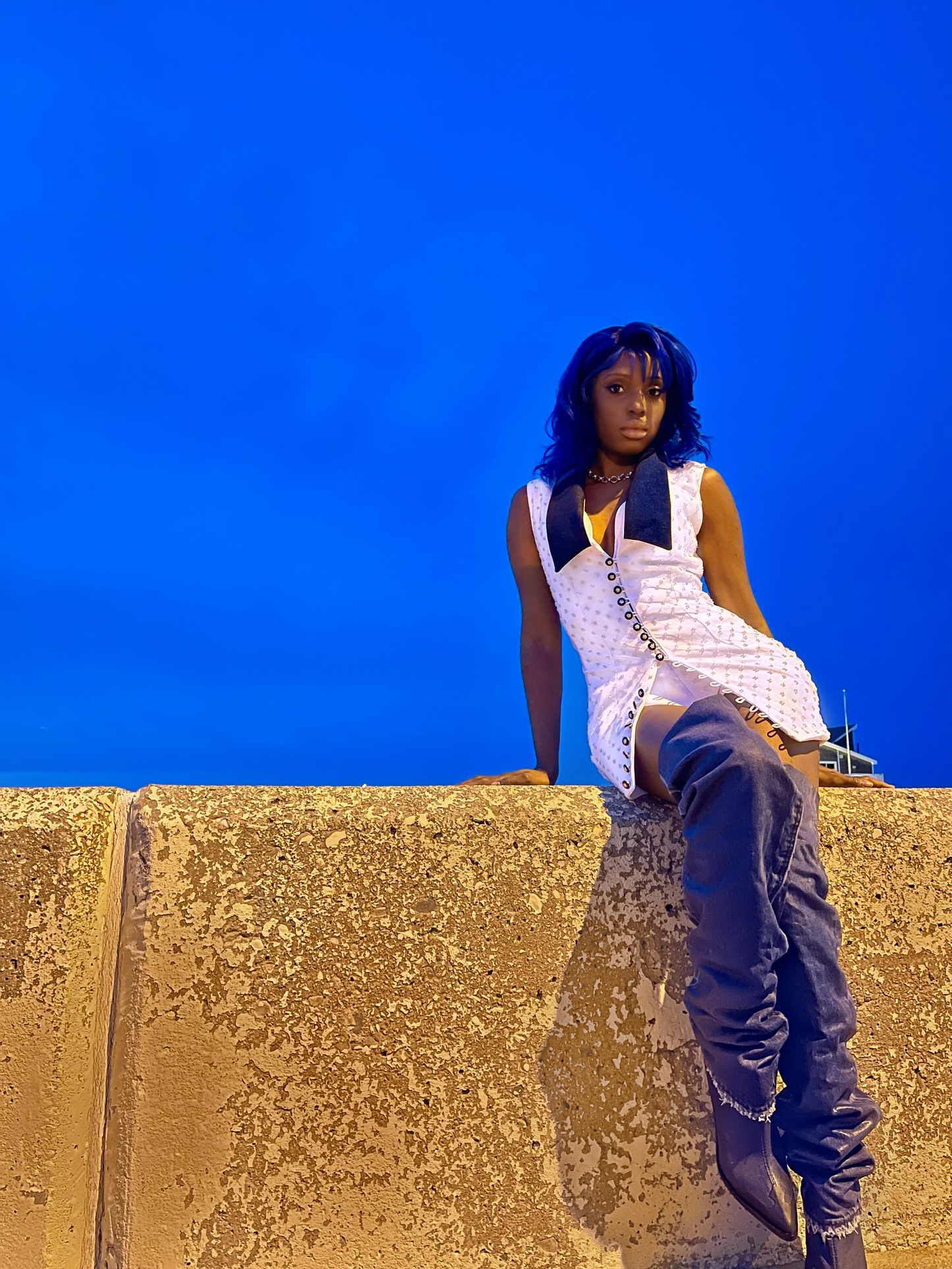 White sleeve less beaded mini dress with denim dark blue lapels.