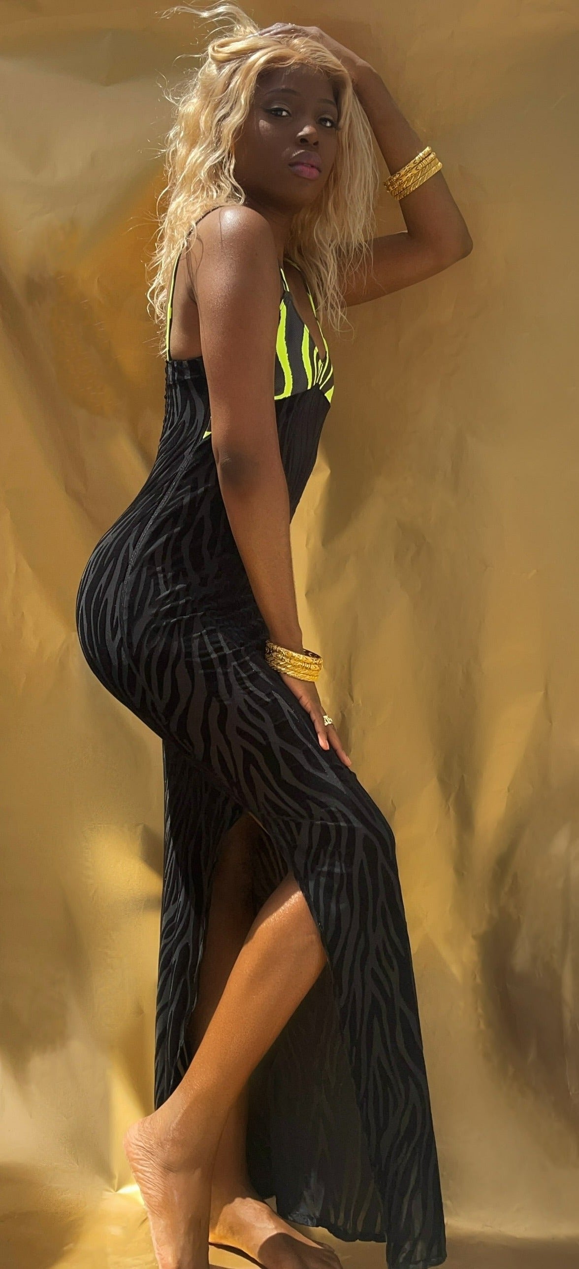 Side view of this slinky neon green and black dress. Sheer velvet mesh mix with neon green tiger stripe top.