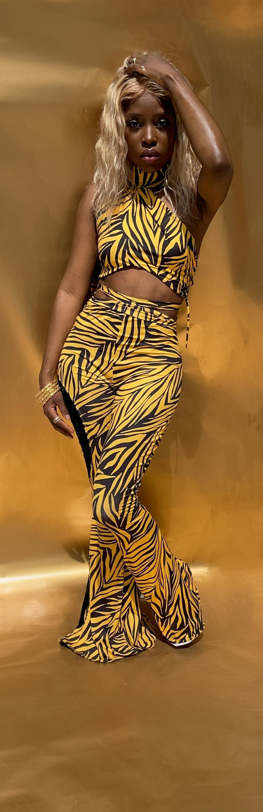 Front view of this yellow and black stripe halter style crop top. Top features a wrap around built in scarf to wear as desired. Top features loop ties on one side, and is fully lined.